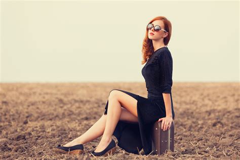 wallpaper women outdoors redhead long hair sunglasses black dress legs sitting field