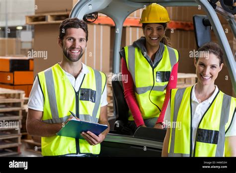 Portrait of warehouse workers and forklift driver Stock Photo - Alamy
