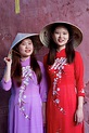 Young Vietnamese women wearing a traditional Ao Dai dress, Vietnam ...