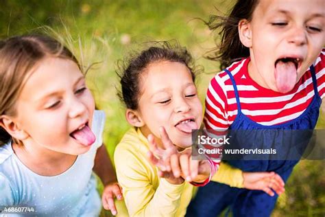 Children Pulling Tongues And Pulling Funny Faces Stock Photo Download