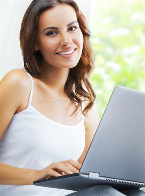 Beautiful Happy Smiling Brunette Woman Using Laptop Sitting Against