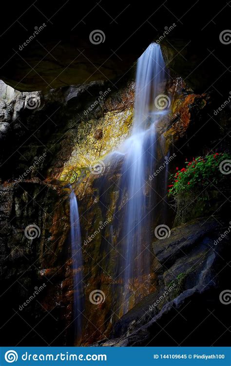 Underground Cave Waterfall Between Rock Formations Stock