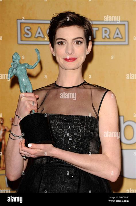 actress anne hathaway poses backstage with the award for best female actor in a supporting role