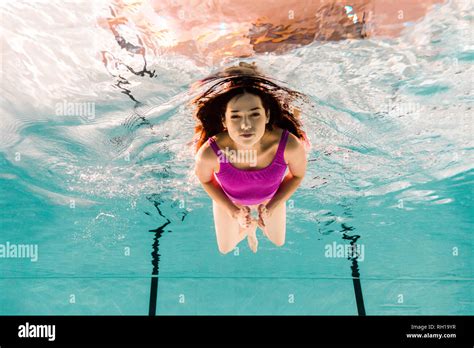 Beautiful Woman Diving Underwater In Swimsuit In Swimming Pool Stock