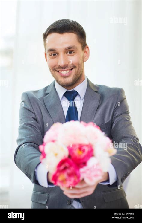 Smiling Handsome Man Giving Bouquet Of Flowers Stock Photo Alamy