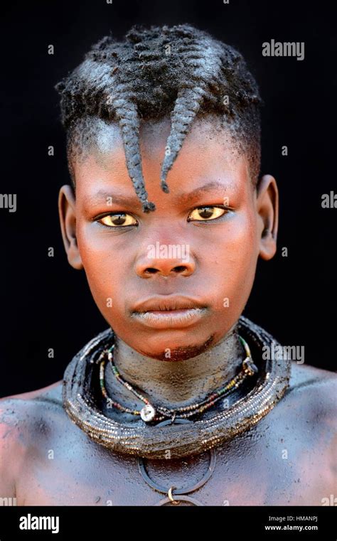 Portrait Of Himba Girl With The Typical Necklace And Double Plait