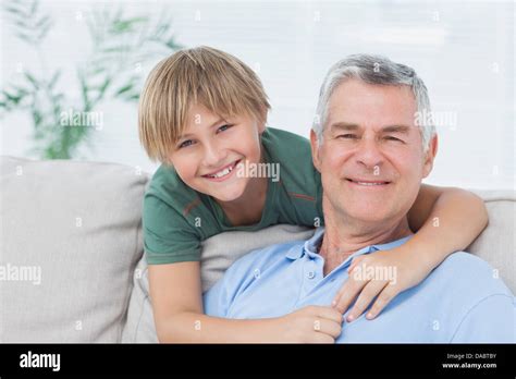 Portrait Of Grandson Embracing Grandfather Stock Photo Alamy