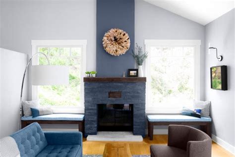 Turquoise chairs break up the neutrals, as does a colorful accent pillow on the sofa. Gray Transitional Living Room With Stone Fireplace | HGTV
