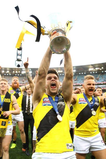 Tigers Captain Trent Cotchin Celebrates With Team Mates And Holds The