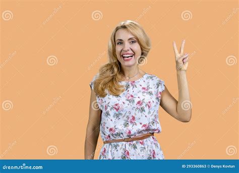 Portrait Of Attractive Blonde Mature Woman Shows Victory Gesture Sign Stock Image Image Of