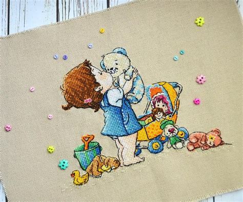 Dimensions baby hugs set of 2 baby bear 9x14 stamped cross stitch bibs 72966. Baby girl with toys cross stitch pattern mom cross stitch ...