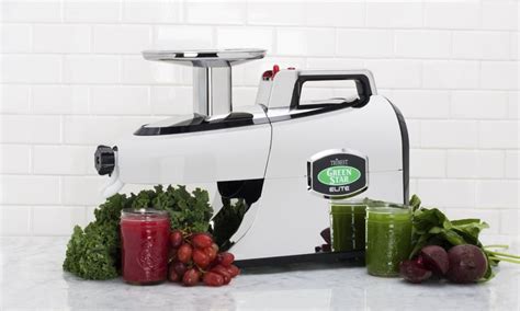 A Juicer Sitting On Top Of A Counter Next To Some Fruit And Veggies