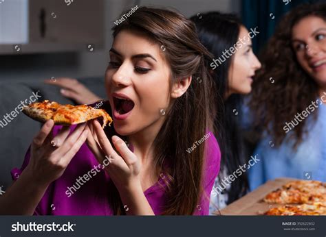 Three Girlfriends Eating Pizza At Home