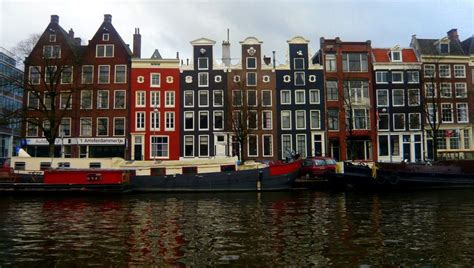 explore the fascinating history behind amsterdam s iconic canal houses and discover why they are