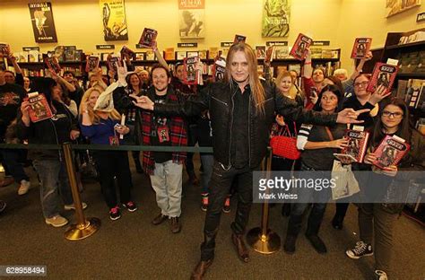 Sebastian Bach Signs Copies Of 18 And Life On Skid Row Photos And