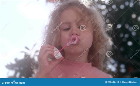 focused little blonde girl in pink blows soap bubbles stock video video of hair blow 288687419