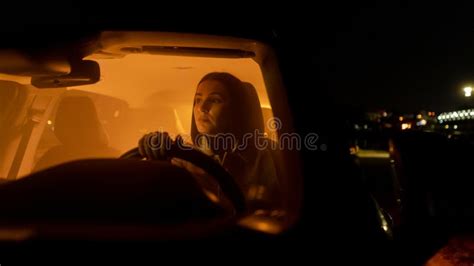 Serious Relaxed Woman Enjoying Night Drive While Sitting In Car And Looking Away At Driver Seat