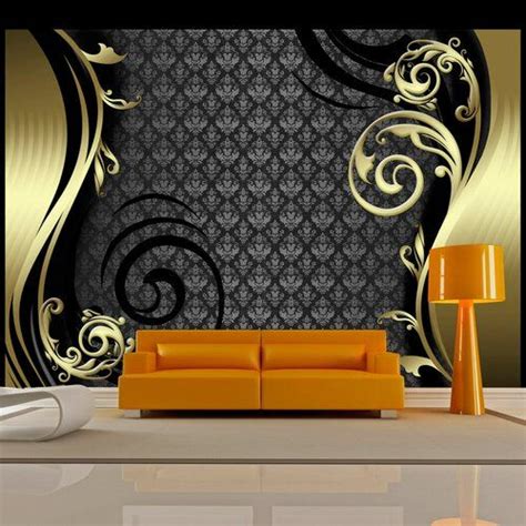An Orange Couch In Front Of A Black And Gold Wallpaper With Swirly Designs