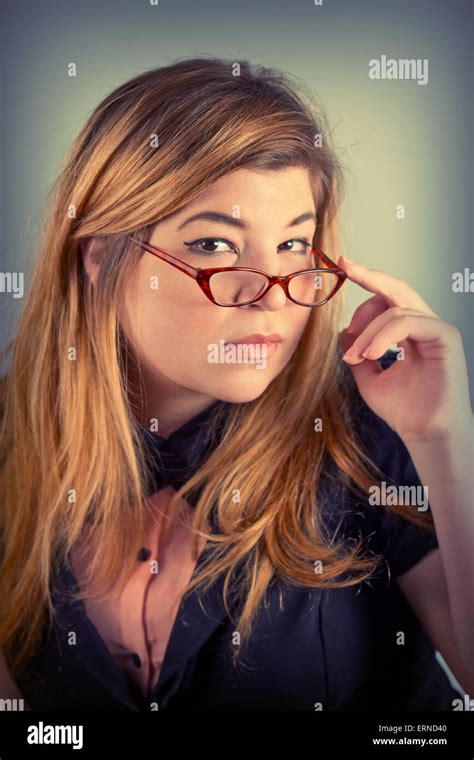 Cute Nerdy Girl With Reading Glasses Posing For A Portrait Stock Photo