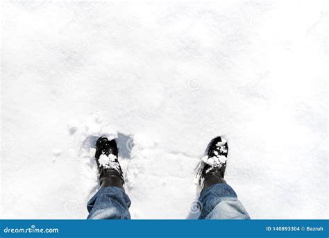Feet In Leather Boots In Deep Snow On Sunny Winter Weather Stock Photo