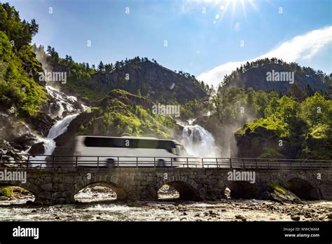 Tourist Bus Traveling On The Road Latefossen Waterfall Odda Norway