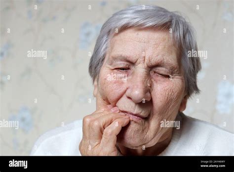 Elderly Woman Holding Her Cheek Female With Gray Hair Suffering From A Toothache Concept Of