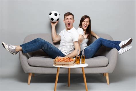 screaming crazy couple woman man football fans cheer up support favorite team with soccer ball