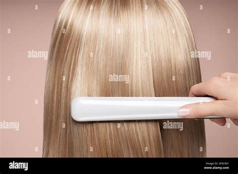 Hairdresser Straightening Long Dark Hair With Hair Irons Beautiful