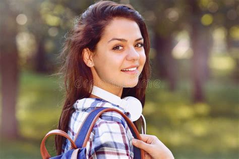 Happy Student Girl With Backpack And Headphones Smile In Summer Park