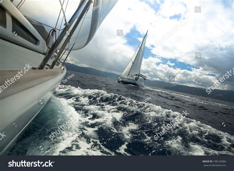 Sailing Ship Yachts With White Sails In The Sea In Stormy Weather