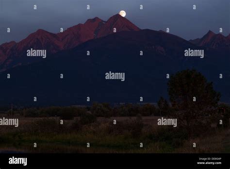 The Full Moon Rises Over The Mission Mountains In Montana Usa As Seen