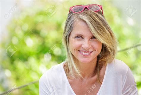 Portrait Of Charming Blond Woman Of Middle Aged Smiling In Glasses
