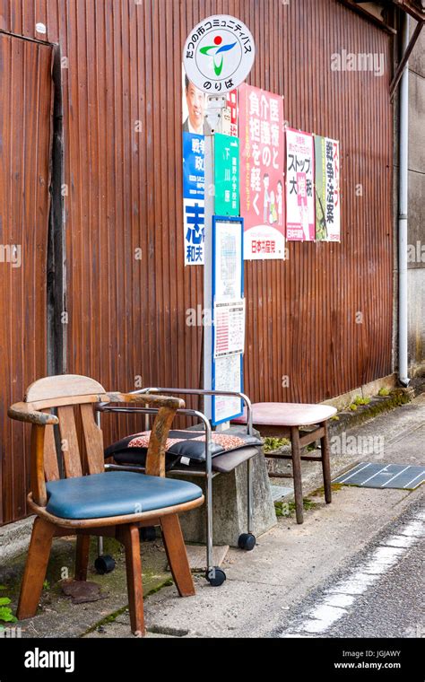 japan rural town tatsuno bus stop with three old chairs left out for people to sit on while