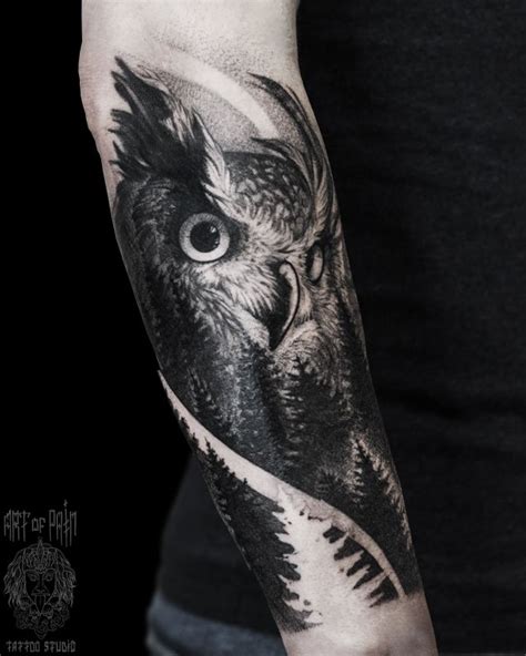 Татуировка женская графика на предплечье сова и лес Art Of Pain