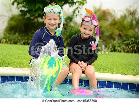 Kids Splashing In Pool Two Children Splashing Water With Swimming Fins