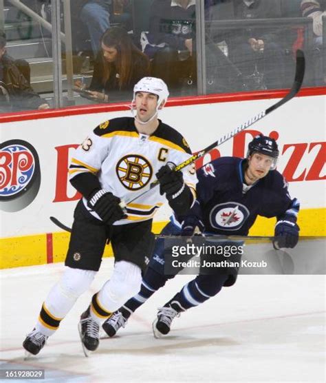 Kyle Wellwood Of The Winnipeg Jets Tries To Look Past Zdeno Chara Of