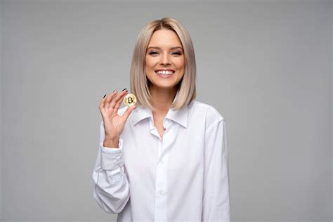 Woman In White Shirt Holding Up Bitcoin Image Free Stock Photo