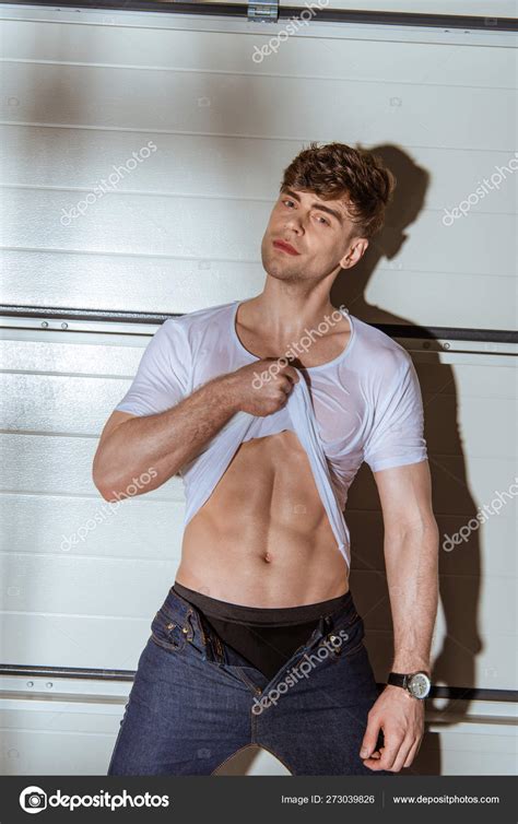 Sexy Muscular Man White Shirt Showing Torso Stock Photo By IgorVetushko