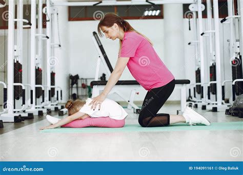 mother with little daughter are engaged in gymnastics in the gym stock image image of female