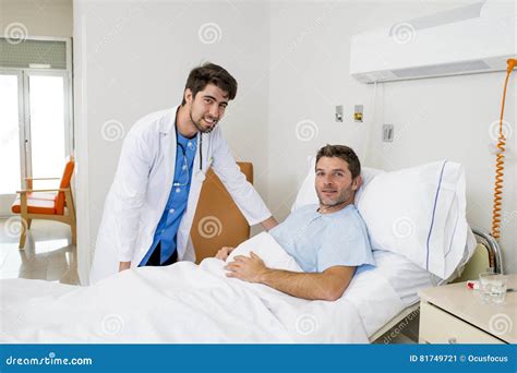 Doctor Consulting Patient Lying On Hospital Bed Talking About The