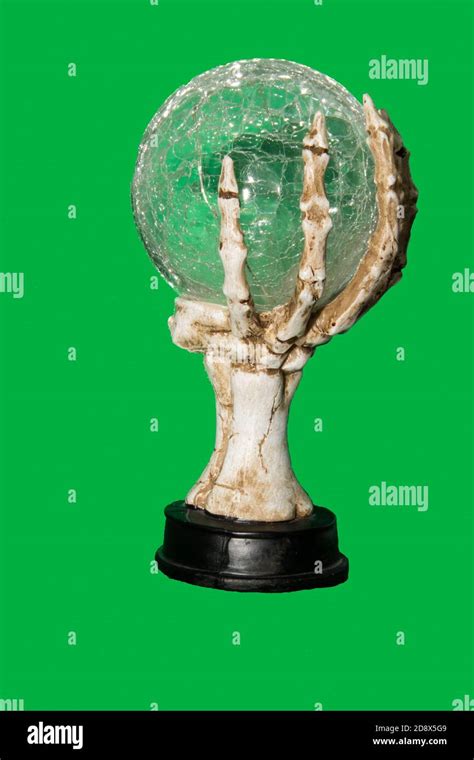 A Skeletal Hand Holding A Crystal Ball With A Green Screen Background