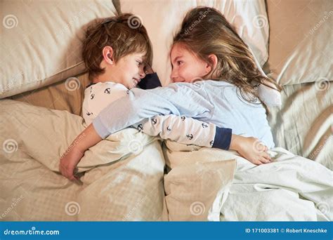 Brother And Sister Cuddle In Bed Stock Image Image Of Bedroom People