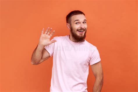 Man Waving Hand And Friendly Smiling At Camera Making Hi Welcome