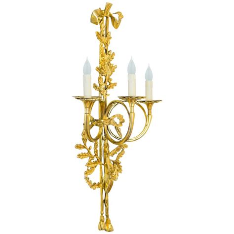 Free shipping & free returns*. Large gilt bronze wall light style Louis XVI three sconces with ribbons