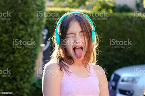 Closeup Portrait Of Funny Preteen Girl With Wireless Headphones On Head