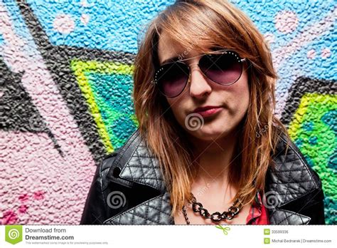 Fashionable Girl And Colorful Graffiti Wall Stock Photo