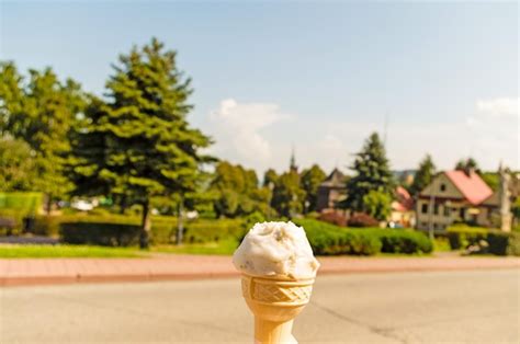 Premium Photo Ice Cream Cone On Glass Against Trees