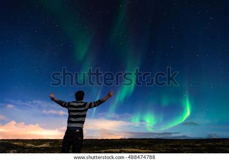 Man Watching Northern Light Over Iceland Horizon Traveler Enjoying The