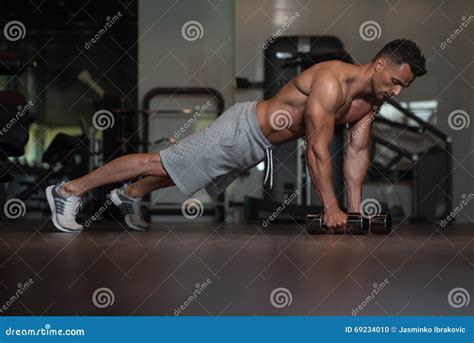 Young Man Doing Push Ups With Dumbbells On Floor Stock Photo Image Of