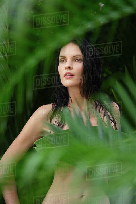 Naked Woman Behind Tropical Leaves Stock Photo Dissolve